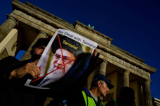 A demonstrator displays a portrait of Iran's supreme leader Ali Khamenei and the word 
