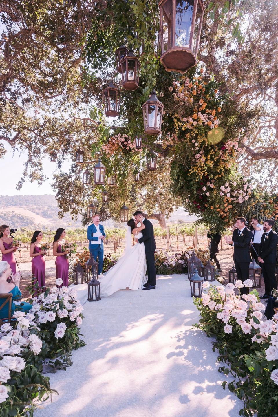 Sarah Hyland and Wells Adams kiss during their wedding ceremony.