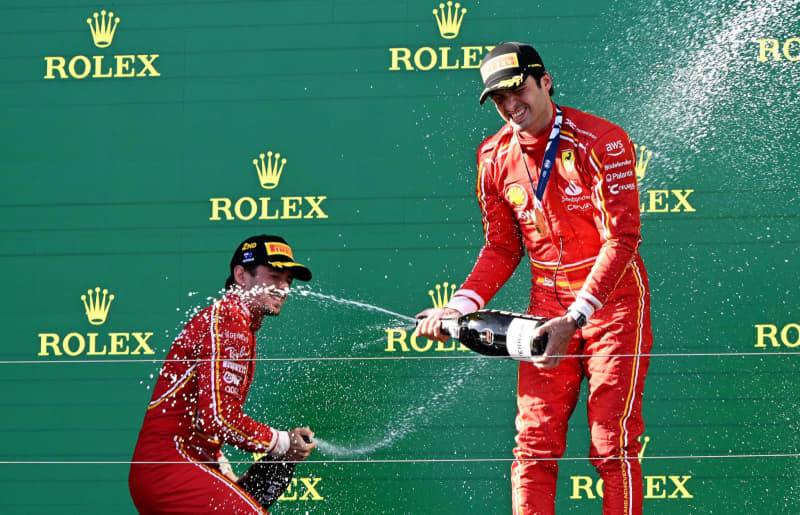 Second-placed Monacan Formula 1 driver Charles Leclerc of Ferrari (L) and Race winner Spanish Formula 1 driver Carlos Sainz of Ferrari celebrate on the podium after the Australian Grand Prix 2024 at Albert Park Circuit in Melbourne. Joel Carrett/AAP/dpa