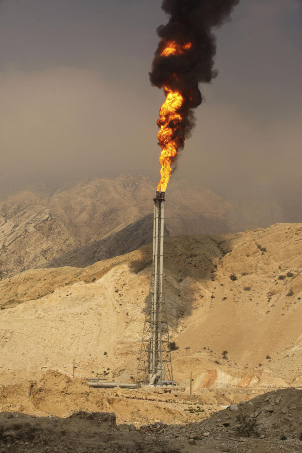 In this picture taken on Wednesday, Jan. 22, 2014, a gas flare burns in a gas refinery at the South Pars gas field on the northern coast of Persian Gulf in Asalouyeh, Iran. With a six-month deal in place easing sanctions as Iran negotiates a final deal with world powers, the government hopes to draw international investment to the natural gas field to spur its production. (AP Photo/Vahid Salemi)