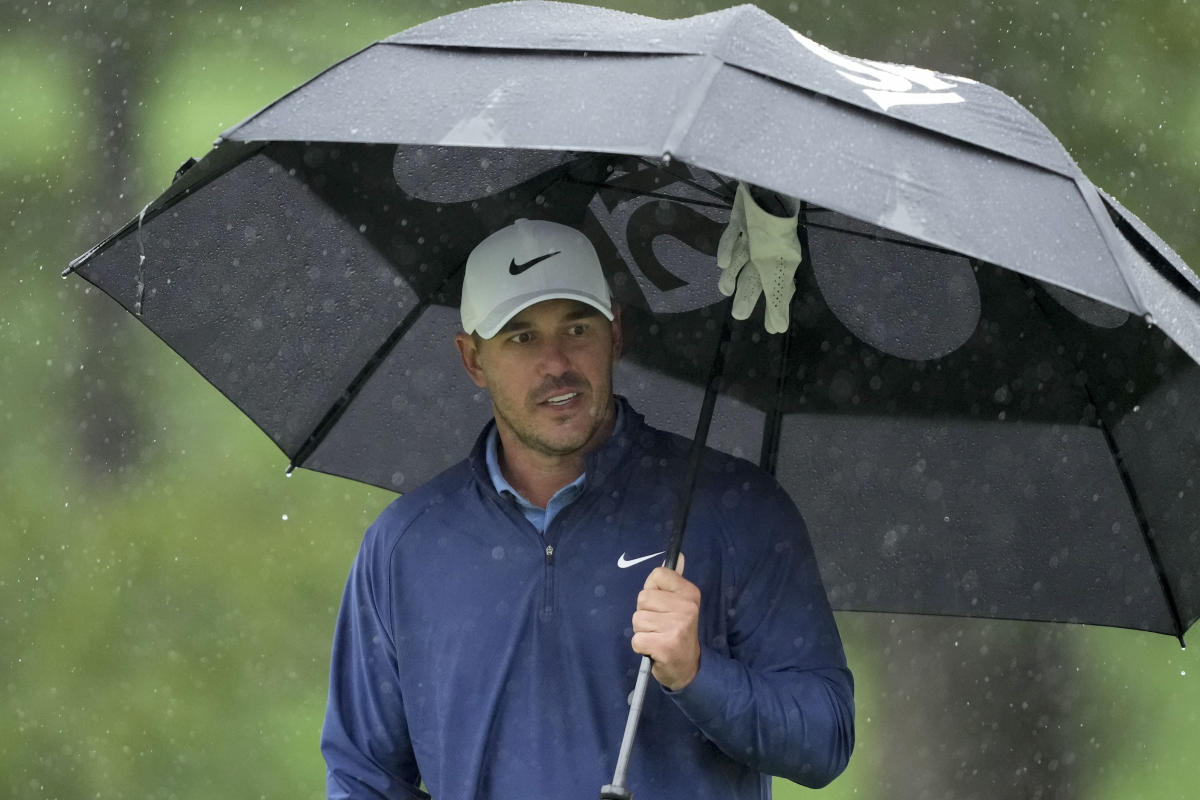 The Masters: Third round suspended as rain drenches field at