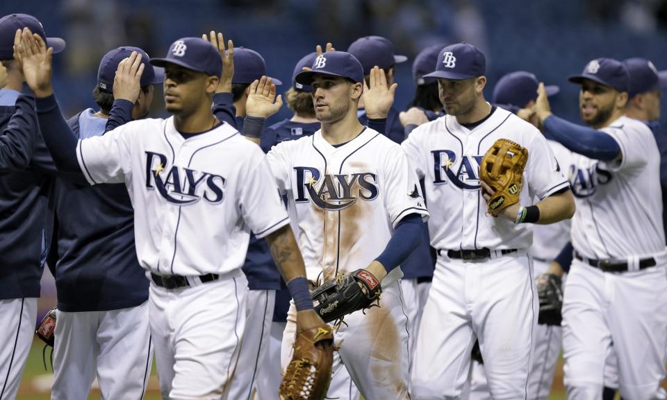 Tampa Bay Rays players celebrate after the team defeated the Seattle Mariners 4-0 during a baseball game Friday, June 6, 2014, in St. Petersburg, Fla.