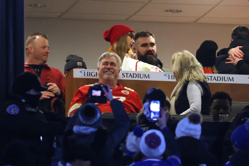 Taylor Swift and Jason Kelce in a suite as fans take pictures prior to the AFC Divisional Playoff between the Kansas City Chiefs and the Buffalo Bills game at Highmark Stadium on Jan. 21, 2024 in Orchard Park, New York. / Credit: Al Bello / Getty Images