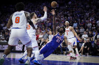 Philadelphia 76ers' Joel Embiid (21) shoots against New York Knicks' Isaiah Hartenstein during the second half of Game 6 in an NBA basketball first-round playoff series, Thursday, May 2, 2024, in Philadelphia. (AP Photo/Matt Slocum)
