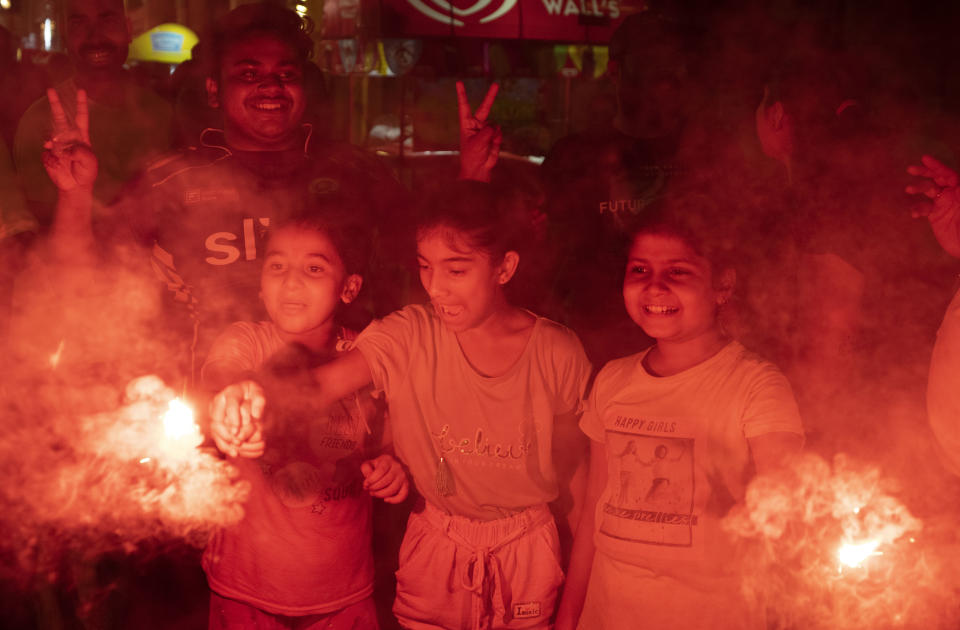 Cricket fans celebrate by lighting firecrackers in Lucknow, capital of northern Indian state of Uttar Pradesh, India, Sunday, June 30, 2024, after India defeated South Africa in the ICC T20 World Cup final match in Barbados. (AP Photo/Rajesh Kumar Singh)