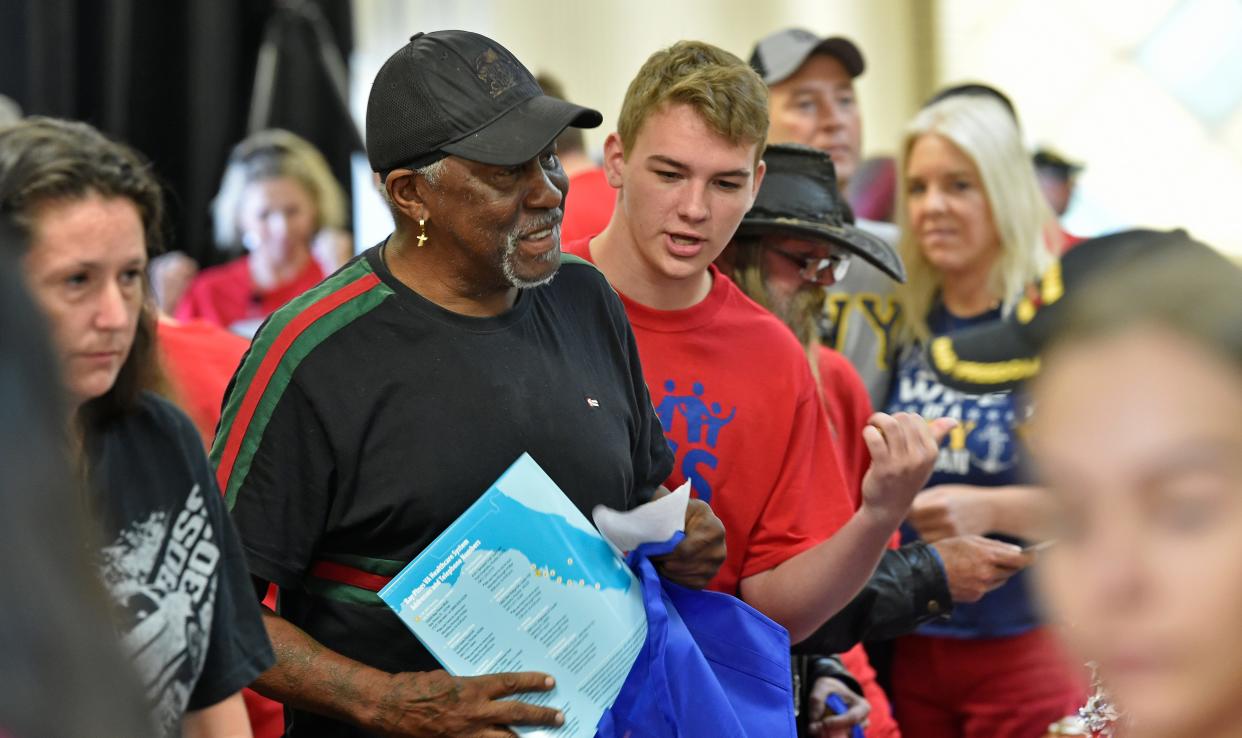 Homeless men and  women line up for assistance at the 11th Annual Sarasota Homeless Veterans Stand Down in April at the Sarasota County Fairgrounds. More than 100 veterans connected with over 40 agencies and businesses.