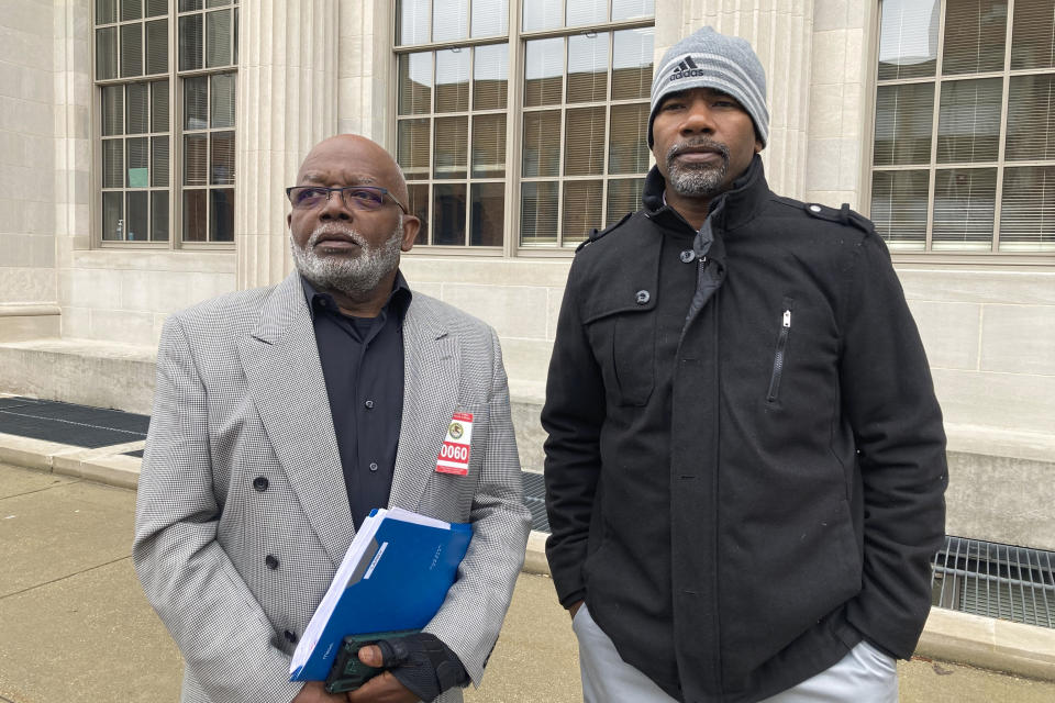 Willie Earvin Jr., 74, left and Larry Pippion, 51, stand after testifying at the sentencing of former state correctional officer Alex Banta at U.S. District Court on Thursday, March 16, 2023, in Springfield, Ill. Banta, 31, was sentenced to 20 years in federal prison for his role in the May 2018 beating death of Larry Earvin, 65, Willie Earvin's brother and Pippion's father. Banta's co-defendants Todd Sheffler and Willie Hedden are scheduled to be sentenced next week. (AP Photo/John O'Connor)