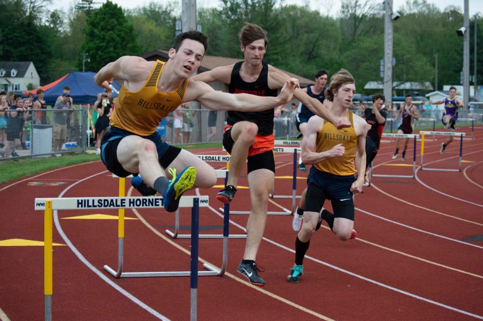 Hillsdale's Stephen Petersen leads a group of hurdlers that includes Jonesville's Damion Scharer and Hillsdale sophomore Brice VanZant.