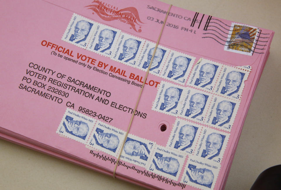 FILE - This Friday, June 10, 2016 file photo shows a mail-in ballot yet to be counted at the Sacramento County Registrar of Voters office, in Sacramento, Calif. Over 100,000 mail-in ballots were rejected by election officials in California's March 2020 presidential primary, highlighting a glaring gap in the effort to ensure every vote is counted as a national dispute rages over the integrity of vote-by-mail elections. (AP Photo/Rich Pedroncelli, File)