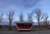 A large replica of a watermelon sits in an empty parking lot Thursday, Jan. 25, 2024, in Green River, Utah. An Australian company and its U.S. subsidiaries are eyeing a nearby area to extract lithium, metal used in electric vehicle batteries. (AP Photo/Brittany Peterson)