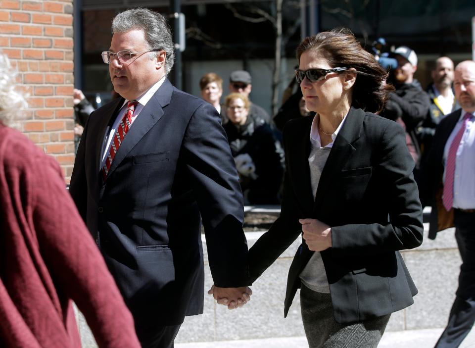 Manuel and Elizabeth Henriquez arrive at federal court in Boston on Wednesday, April 3, 2019, to face charges in a nationwide college admissions bribery scandal.