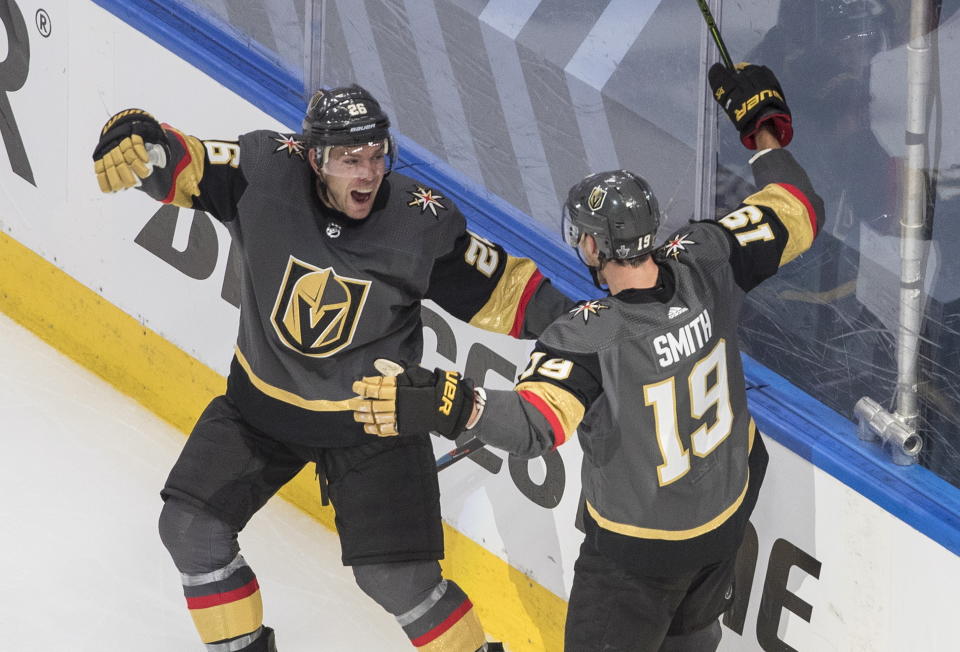 Vegas Golden Knights' Paul Stastny (26) and Reilly Smith (19) celebrate a goal against the Chicago Blackhawks during overtime in an NHL hockey Stanley Cup first-round playoff series, Thursday, Aug. 13, 2020, in Edmonton, Alberta. (Jason Franson/The Canadian Press via AP)