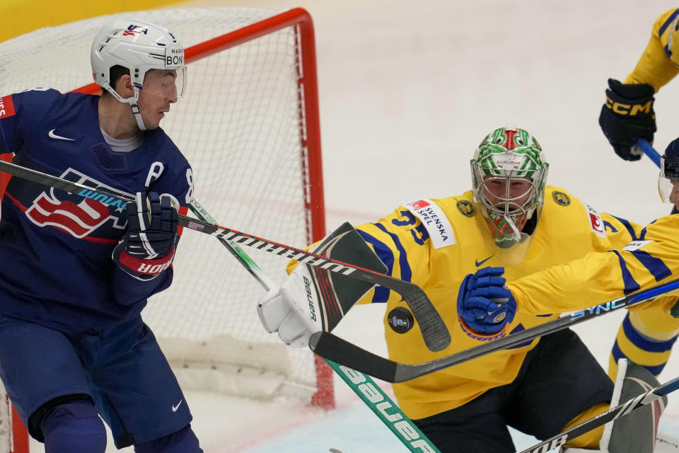 Sweden's goalkeeper Filip Gustavsson, right, makes a save in front of Unted States' Zach Werenski, left, during the preliminary round match between Sweden and United States at the Ice Hockey World Championships in Ostrava, Czech Republic, Friday, May 10, 2024. (AP Photo/Darko Vojinovic)