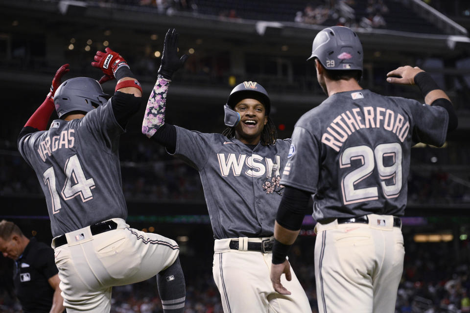 Washington Nationals' CJ Abrams, center, celebrates his three-run home run against the Philadelphia Phillies with Ildemaro Vargas (14) and Blake Rutherford (29) during the fourth inning of a baseball game Friday, Aug. 18, 2023, in Washington. (AP Photo/Nick Wass)