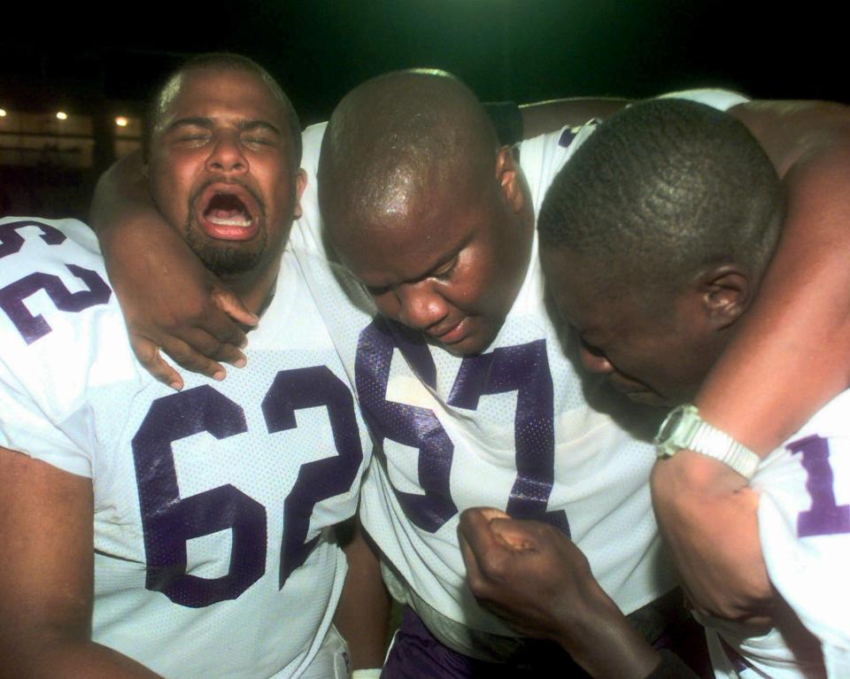 In this Sept. 26, 1998 file photo, Prairie View A&M players Kevin Jefferson (62) and Eian Preston (67) and an unidentified teammate cry in joy after they snapped an 80-game losing streak with a 14-12 win over Langston, in Oklahoma City. The longest losing streak in college football history wasn't enough to scare away Greg Johnson. One win, albeit an elusive one, was all he would need to change history and Greg Johnson figured he could get it done.