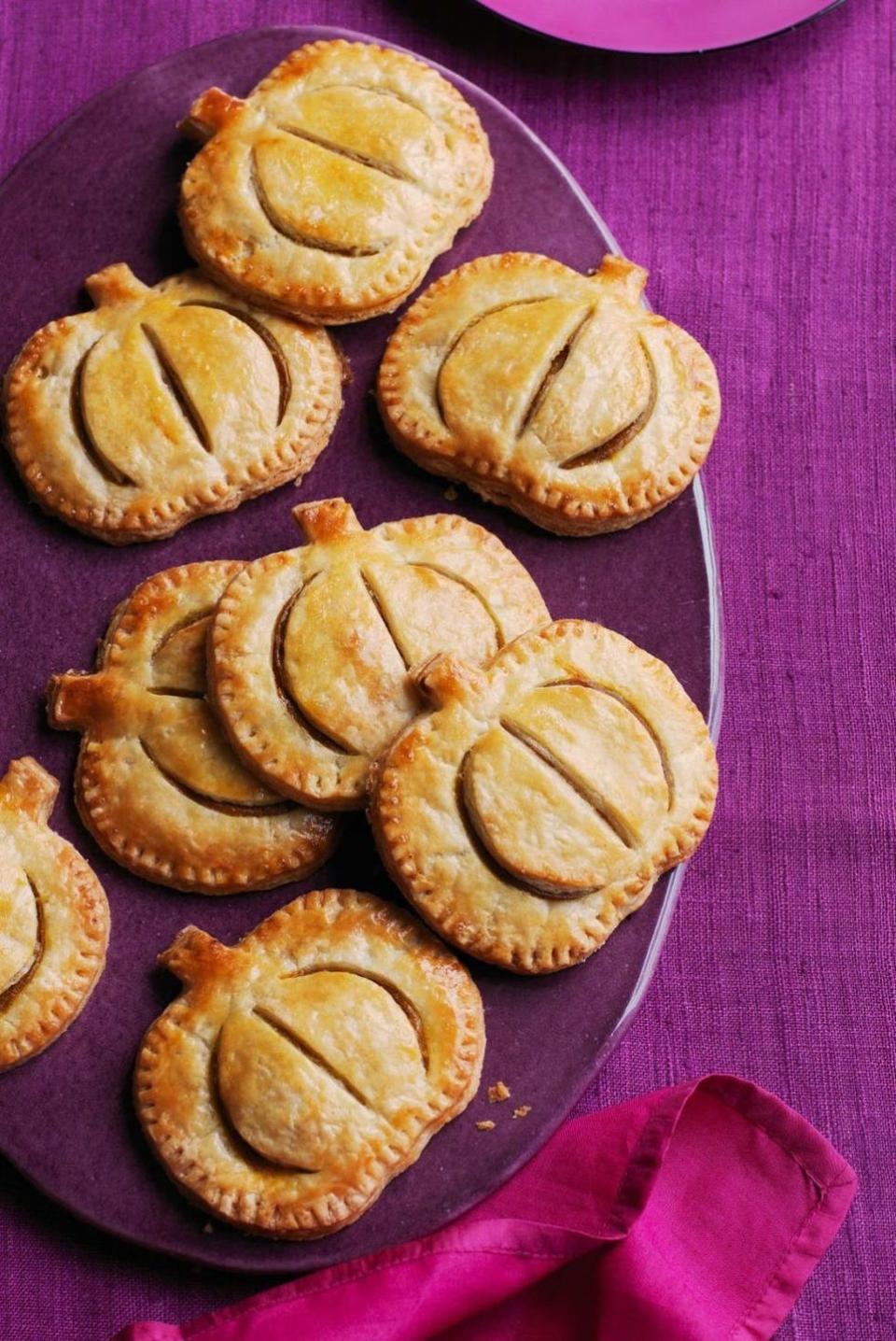 <p>A perfect way for your guests to enjoy pumpkin pie without having to sit down at a table. </p><p>Get the <strong><a href="https://www.womansday.com/food-recipes/food-drinks/recipes/a52046/pumpkin-hand-pies/" rel="nofollow noopener" target="_blank" data-ylk="slk:Pumpkin Hand Pies recipe;elm:context_link;itc:0;sec:content-canvas" class="link ">Pumpkin Hand Pies recipe</a></strong>.</p>