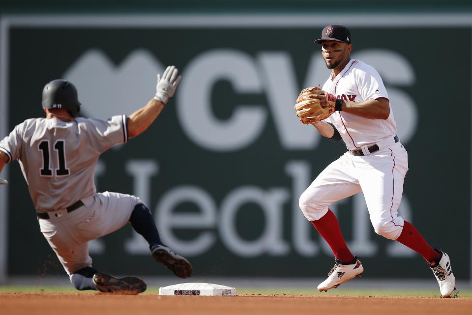 New York Yankees' Brett Gardner (11) is forced out at second base as Boston Red Sox's Xander Bogaerts sets up to turn the double play on Didi Gregorius during the fourth inning of a baseball game in Boston, Saturday, Aug. 4, 2018. (AP Photo/Michael Dwyer)