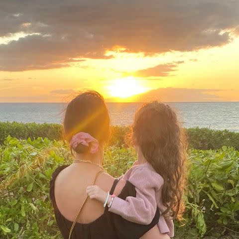 <p>Lacey Chabert Instagram</p> Lacey Chabert watching a sunset with her daughter, Julia Mimi Bella.