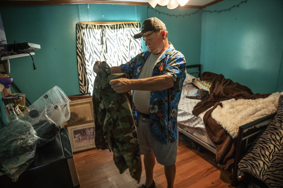 Fred VanDerzee, holds a jacket belonging to his son-in-law, Sgt. James Johnston, who was killed in Afghanistan in June, in the room he once shared with Fred's daughter, Krista, in Trumansburg, N.Y., Saturday, Aug. 31, 2019. VanDerzee was so fond of him he called him the "son I never had." (AP Photo/David Goldman)