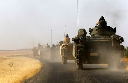 Turkish armoured personnel carriers drive towards the border in Karkamis on the Turkish-Syrian border in the southeastern Gaziantep province, Turkey, August 27, 2016. REUTERS/Umit Bektas/File Photo