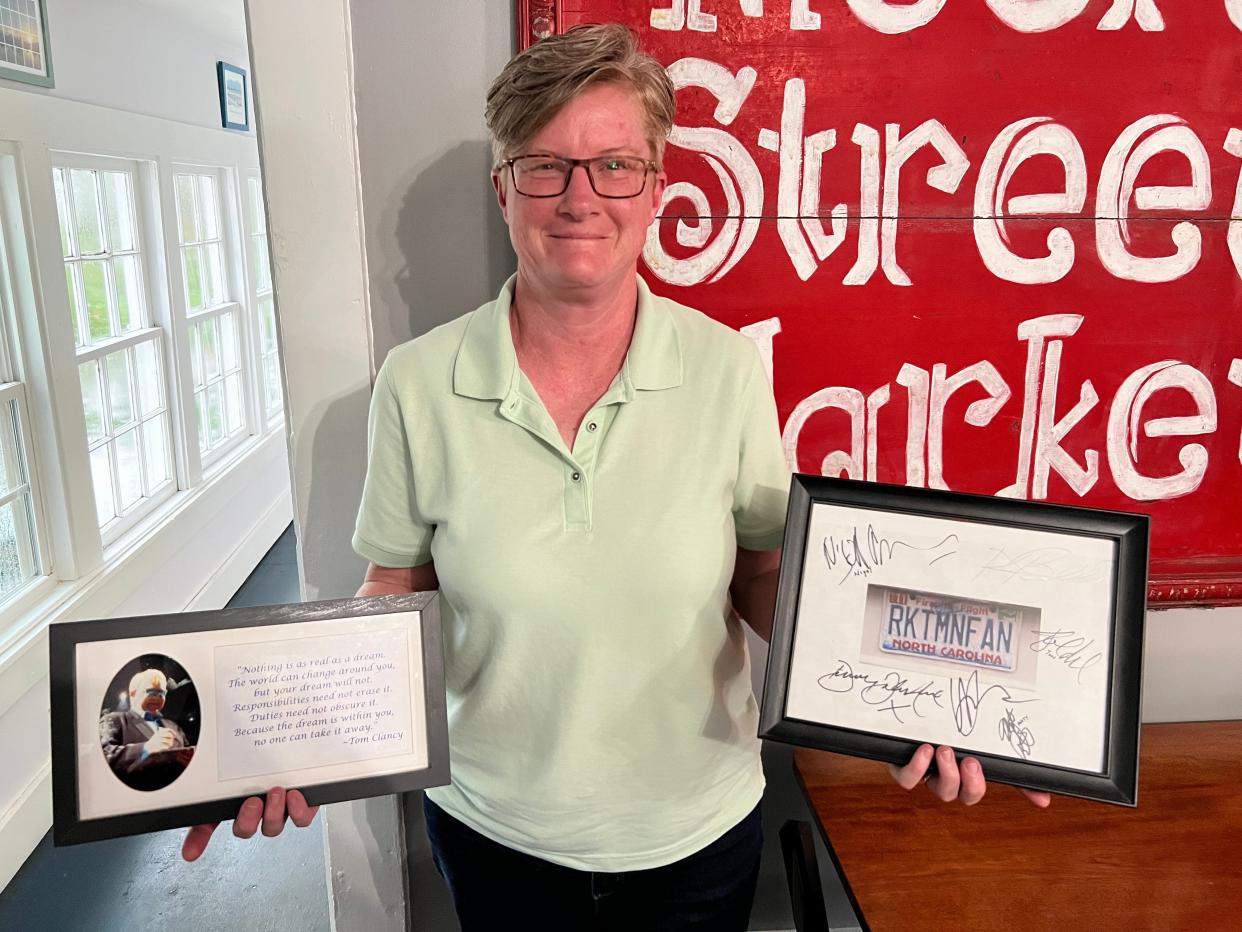 Melissa Thomas shows off two of her most prized possessions: a photo of Elton John she took at one of his concerts and an autographed photograph of her license plate, which is also a tribute to one of the singer's most popular songs.