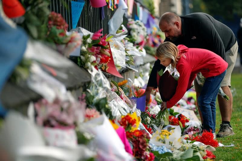 Thousands of people paid tribute Sunday at makeshift memorials to the 50 people slain by a gunman at two mosques in Christchurch. Source: AP