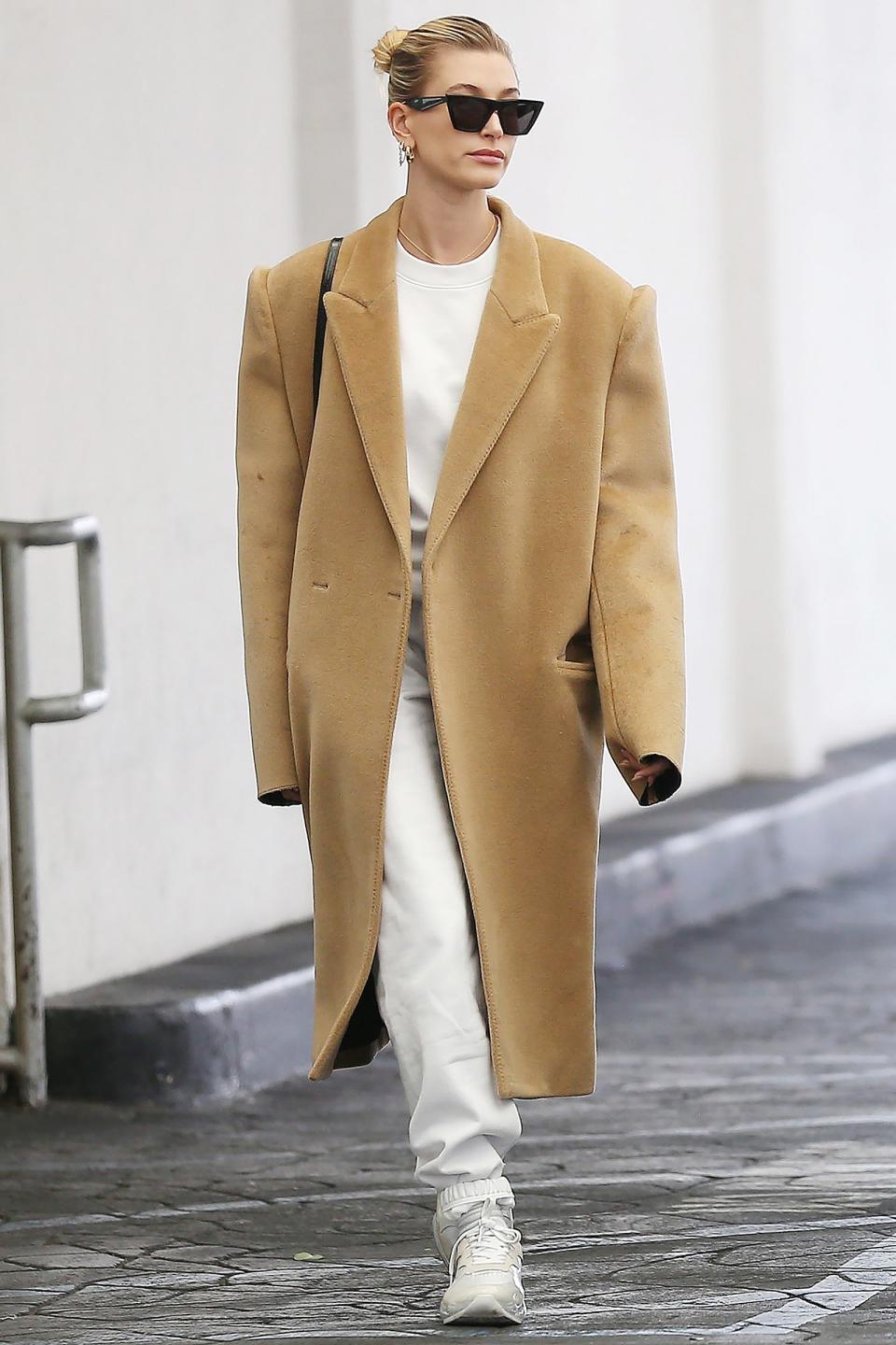 Hailey Baldwin keeps cozy in an oversized camel coat while out and about on Tuesday in L.A.