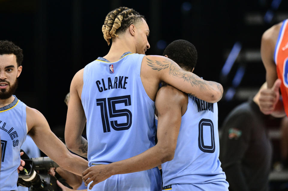 Memphis Grizzlies forward Brandon Clarke (15) and guard De'Anthony Melton (0) celebrate on the court in the first half of an NBA basketball game against the Oklahoma City Thunder, Thursday, Dec. 2, 2021, in Memphis, Tenn. (AP Photo/Brandon Dill)