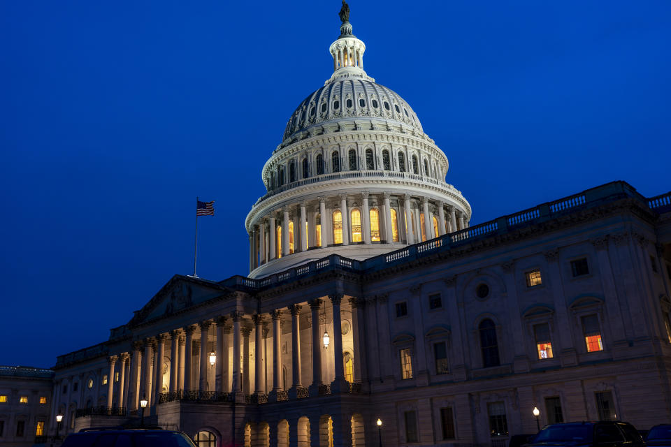 The U.S> Capitol in Washington is illuminated Friday evening, Feb. 9, 2024, as the Senate settles in for a rare weekend session to work on a package of wartime funding for Ukraine, Israel and other U.S. allies. (AP Photo/J. Scott Applewhite)