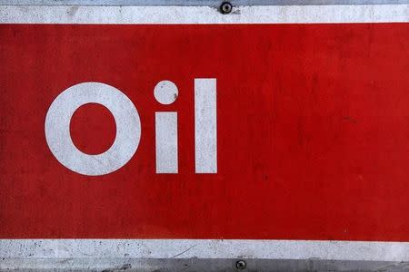 The word oil is pictured on an oil bank at a recycling yard in London March 2, 2011. REUTERS/Stefan Wermuth/File Photo