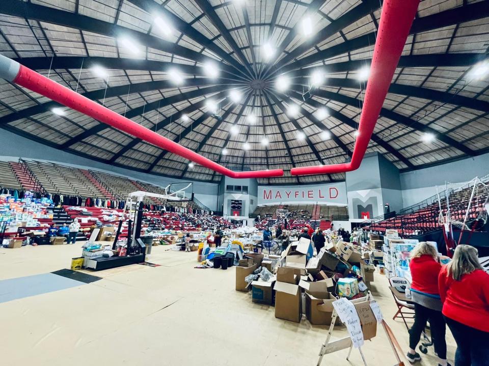 Volunteers give out supplies to tornado victims in the Mayfield High School gymnasium in Mayfield, Ky., in December 2021 after the western Kentucky town was devastated by tornadoes.