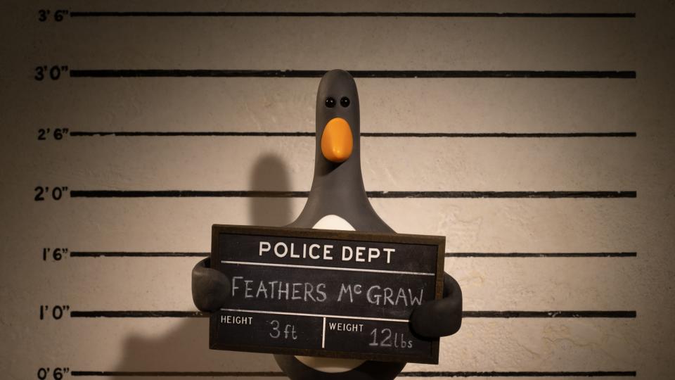 Penguin character Feathers McGraw holding up a sign for a police line-up in 