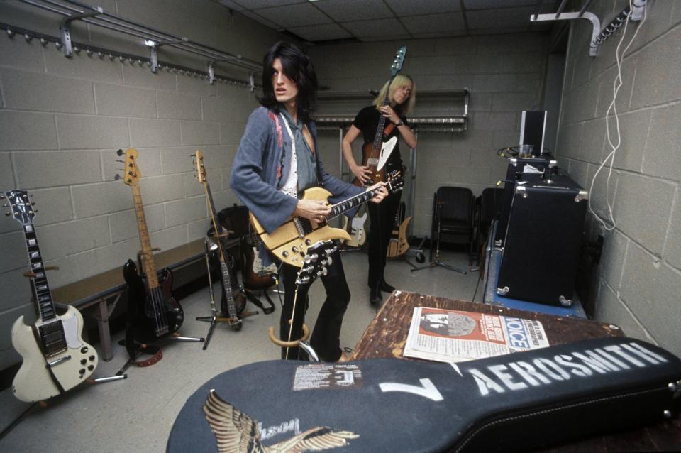 <p>Aerosmith's Tom Hamilton and Joe Perry warm up backstage at Madison Square Garden before a concert in 1976. </p>