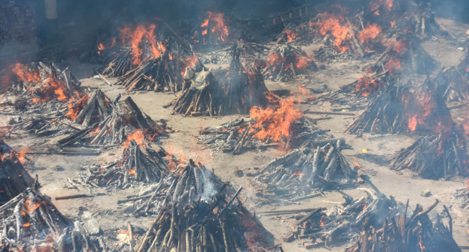 Multiple funeral pyres of people who died of Covid-19 burning simultaneously at Gazipur crematorium on April 24, 2021 in New Delhi, India.