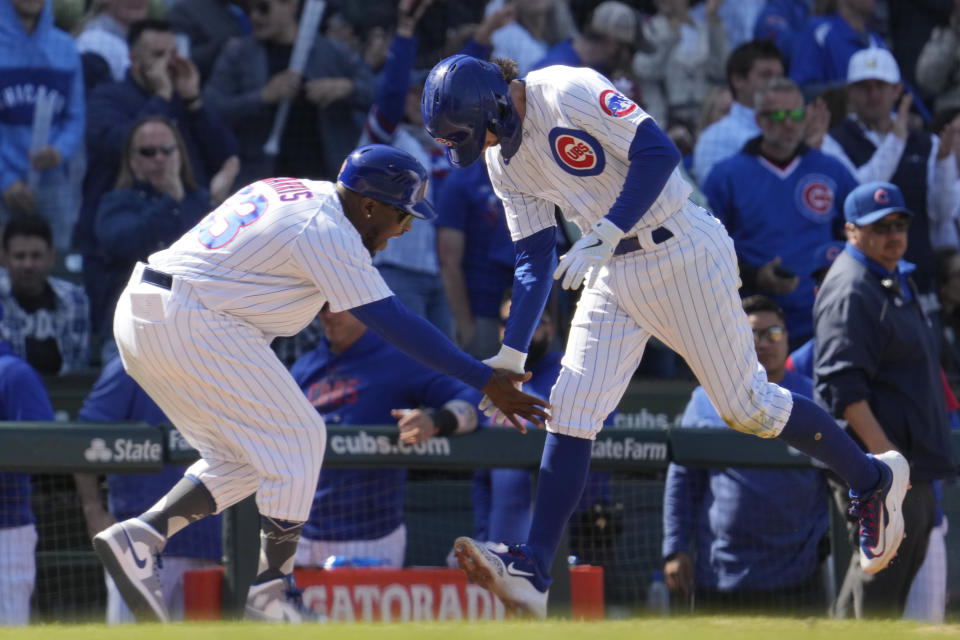 Chicago Cubs' Dansby Swanson, right, celebrates with third base coach Willie Harris after hitting a solo home run during the seventh inning of a baseball game against the San Diego Padres in Chicago, Thursday, April 27, 2023. The Cubs won 5-2. (AP Photo/Nam Y. Huh)