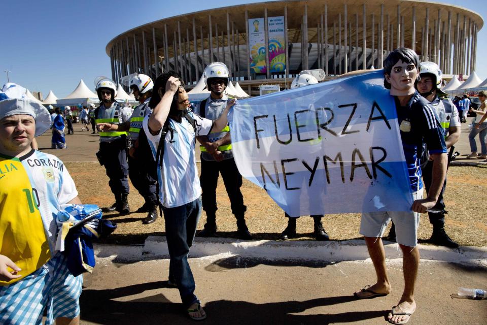 Fans of Argentina&#39;s national soccer team hold a banner with a message that reads in Spanish; &quot;Strength Neymar,&quot; as they wait to enter the Estadio Nacional for the World Cup quarterfinal match between Argentina and Belgium, in Brasilia, Brazil Saturday, July 5, 2014. Neymar, the biggest football star in Brazil, was ruled out of the rest of the tournament after fracturing his third vertebra during Friday&#39;s 2-1 quarterfinal win over Colombia. (AP Photo/Rodrigo Abd)