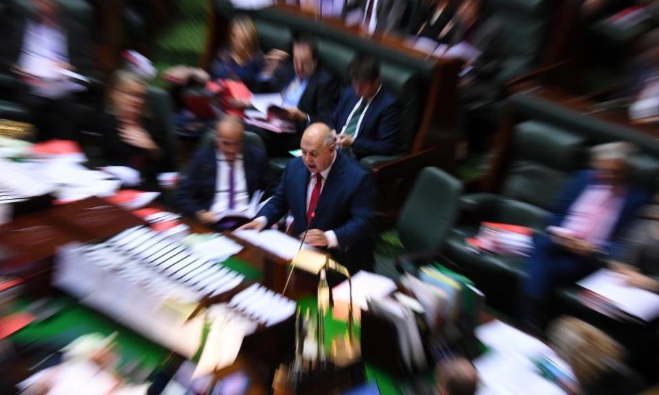 Victorian treasurer Tim Pallas (centre) delivers his budget speech on Thursday.