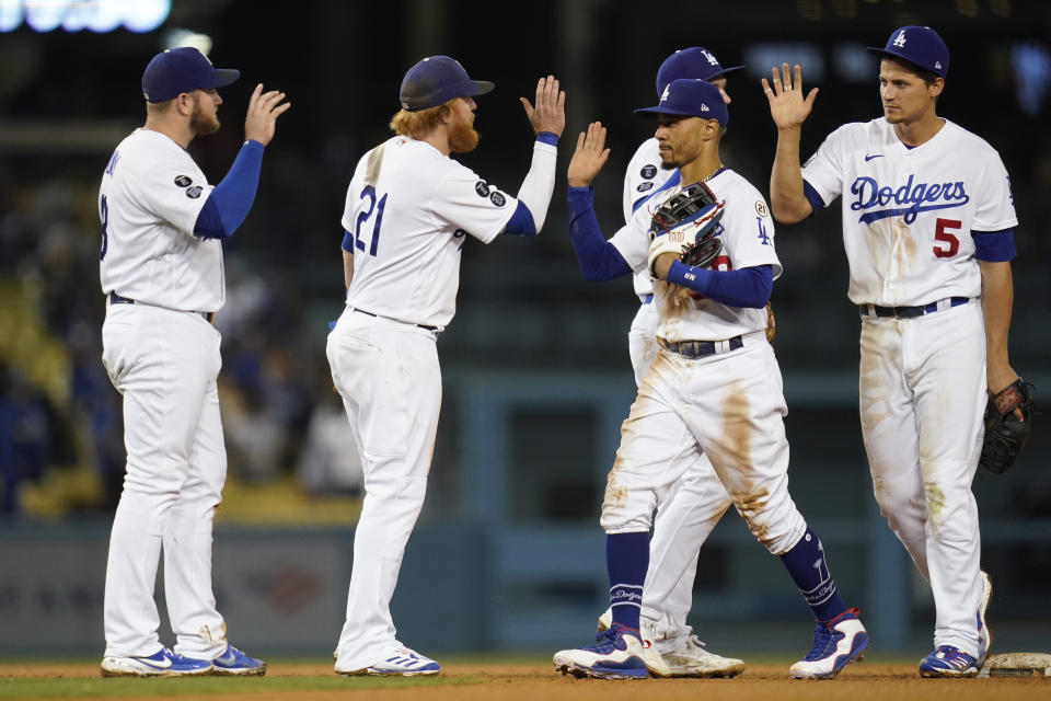 The Los Angeles Dodgers celebrate after a 5-3 win over the Arizona Diamondbacks in a baseball game Wednesday, Sept. 15, 2021, in Los Angeles. (AP Photo/Ashley Landis)