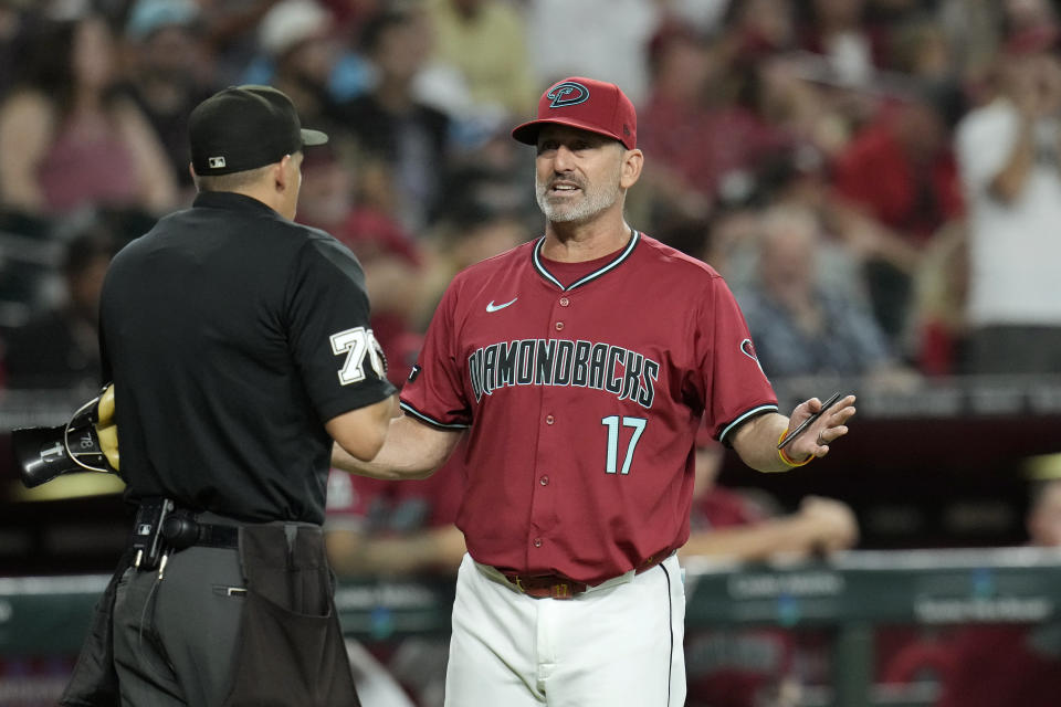 Arizona Diamondbacks manager Torey Lovullo (17) argues with umpire Adam Hamari, left, during the first inning of a baseball game against the Oakland Athletics, Saturday, June 29, 2024, in Phoenix. (AP Photo/Ross D. Franklin)