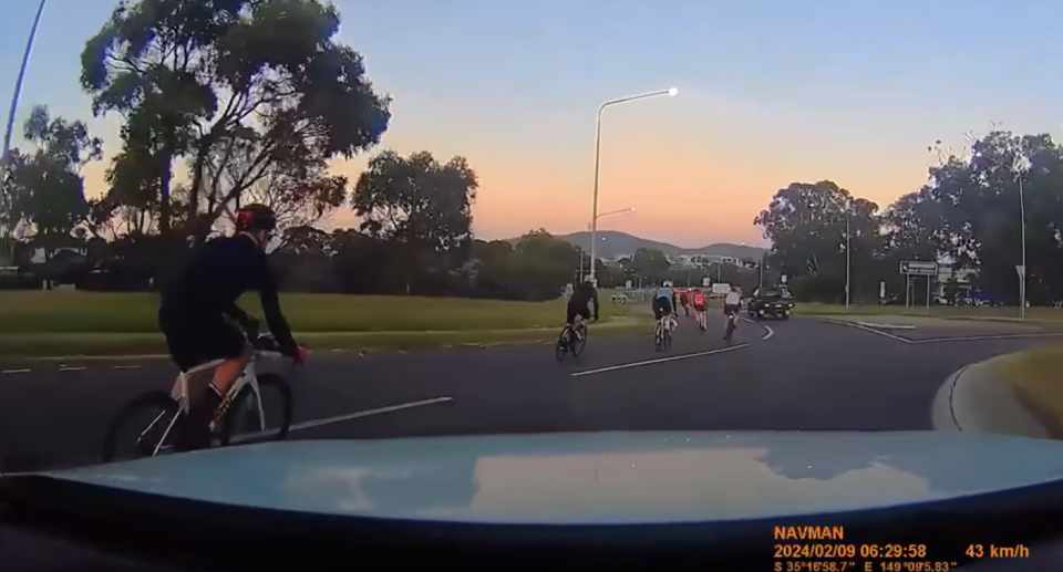 The first cyclist moving into the driver's lane as they crossed the roundabout in Canberra. 