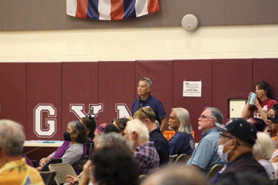 Residents of Pahala, Hawaii, a rural town of about 1,400 on the south side of the Big Island, listen a report about the recent activity on Mauna Loa at the local gymnasium on Thursday, Oct. 27, 2022. The ground is shaking and swelling at Mauna Loa, the largest active volcano in the world, indicating that it could erupt. Scientists say they don't expect that to happen right away but officials on the Big Island of Hawaii are telling residents to be prepared. (AP Photo/Megan Moseley)