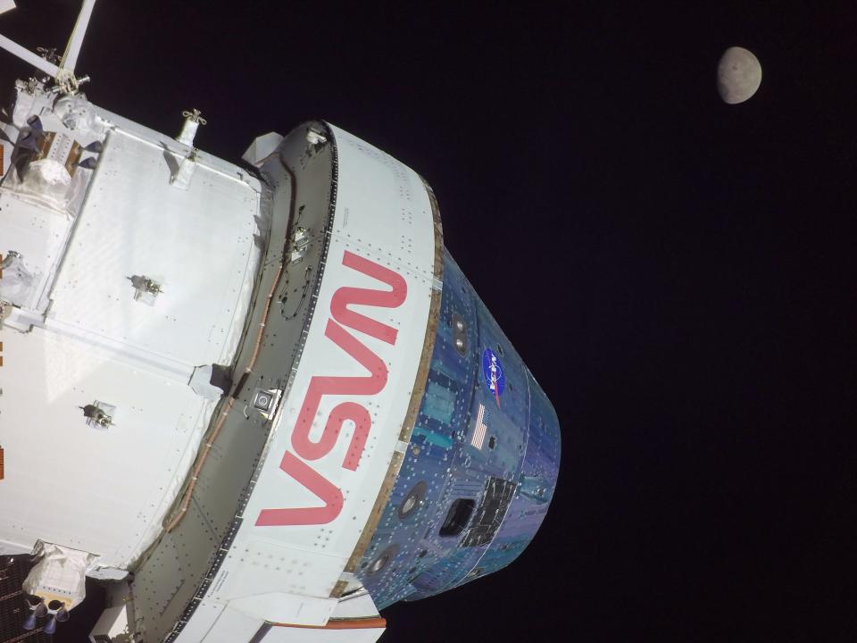 spaceship with nasa written on it in space with moon in distance