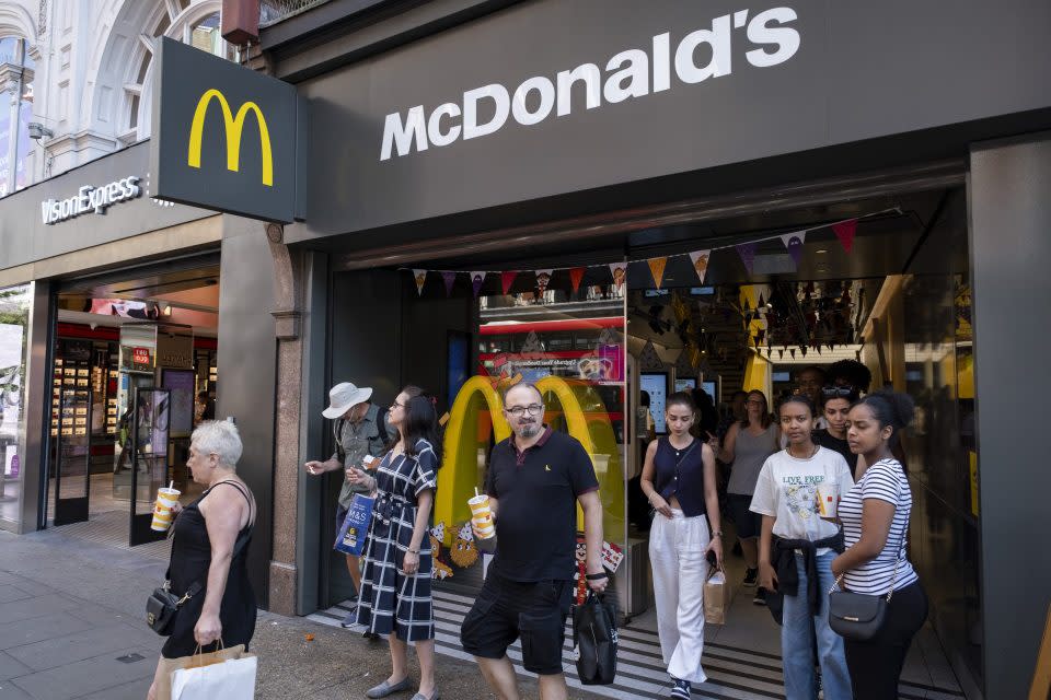 people walking out of a mcdonald's store