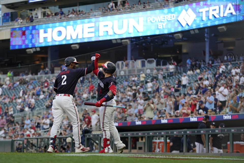 Minnesota Twins' Michael A. Taylor (2), left, celebrates with Christian Vazquez after hitting a solo home run during the fifth inning of a baseball game against the Cleveland Guardians, Thursday, June 1, 2023, in Minneapolis. (AP Photo/Abbie Parr)