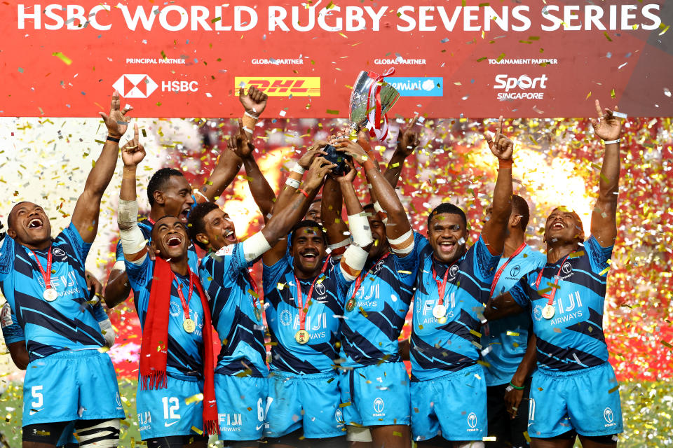 Fiji celebrate with the winners' trophy after their Cup final victory against New Zealand at the HSBC Singapore Rugby Sevens tournament. 