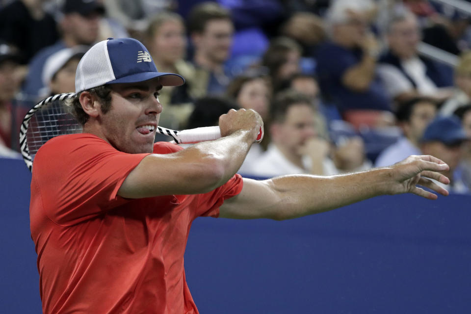 Reilly Opelka returns a shot to Dominik Koepfer, of Germany, during the second round of the U.S. Open tennis tournament Wednesday, Aug. 28, 2019, in New York. (AP Photo/Adam Hunger)