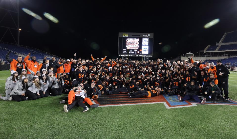 The Massillon Tigers gather for a team photo after defeating Hoban to win the OHSAA Division II state championship Thursday in Canton.