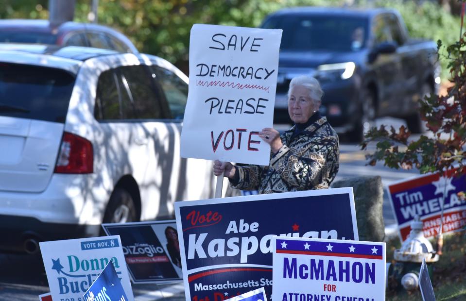 YARMOUTHPORT 11/08/22 Anne Grammer holds her voting democracy sign high for passing motorists outside the First Congregational Church in Yarmouthport where voters in precinct one cast their ballots. Cape Cod Times/Steve Heaslip