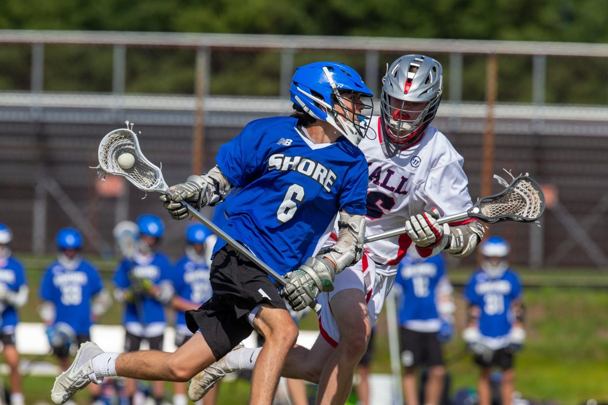 Shore Regional's Carson Spallone is challenged by Wall's Ryan Brice during the Shore Conference Tournament boys lacrosse quarterfinals at the Wall Township High School in Wall, NJ Tuesday, May 25, 2021.