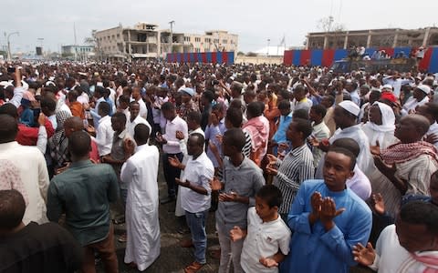 Thousands of Somalis gather to pray at the site of the country's deadliest attack and to mourn the hundreds of victims, at the site of the attack in Mogadishu, Somalia Friday, Oct. 20, 2017 - Credit: AP